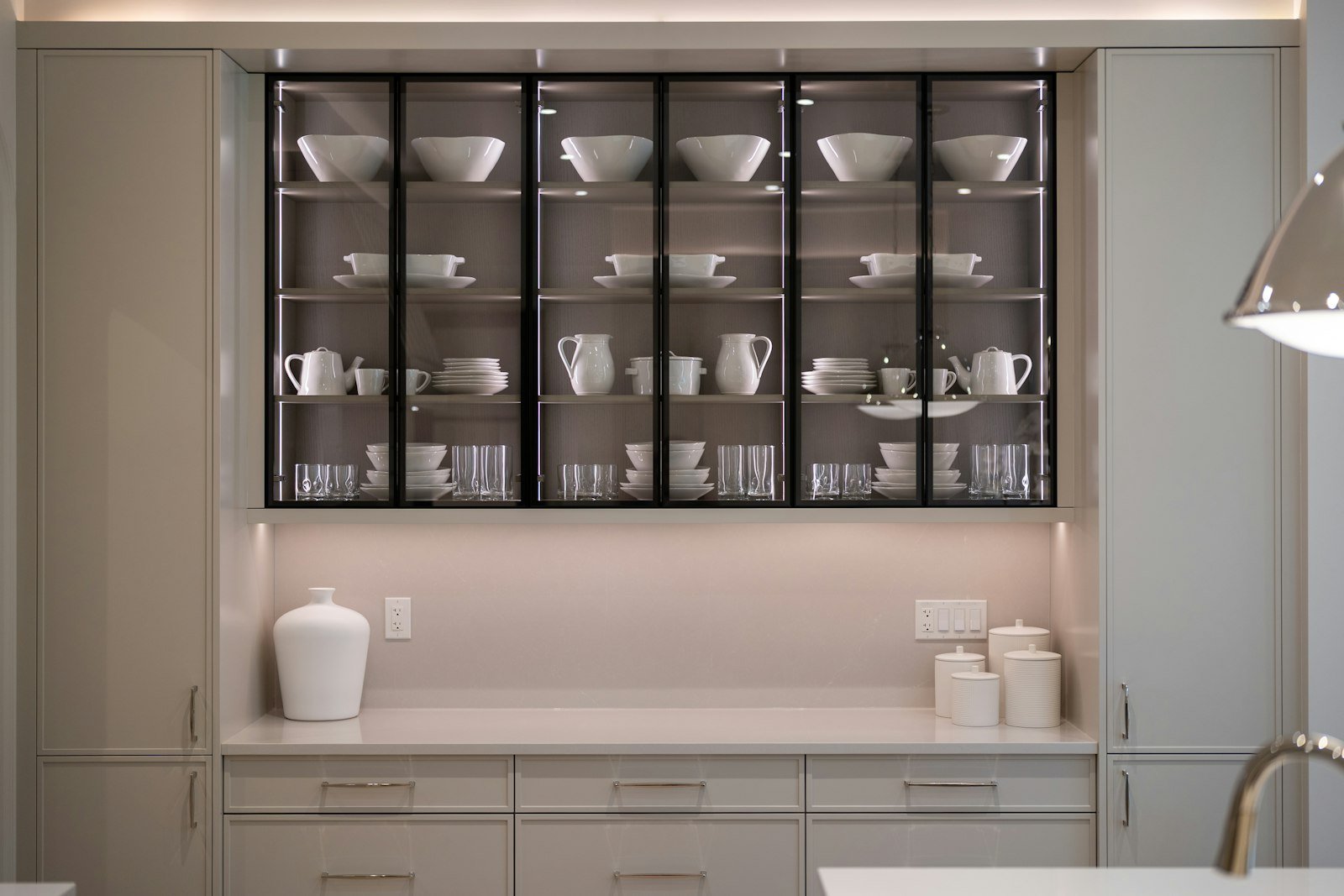 Organized kitchen cabinet showcasing kitchen organization hacks with neatly arranged dishware